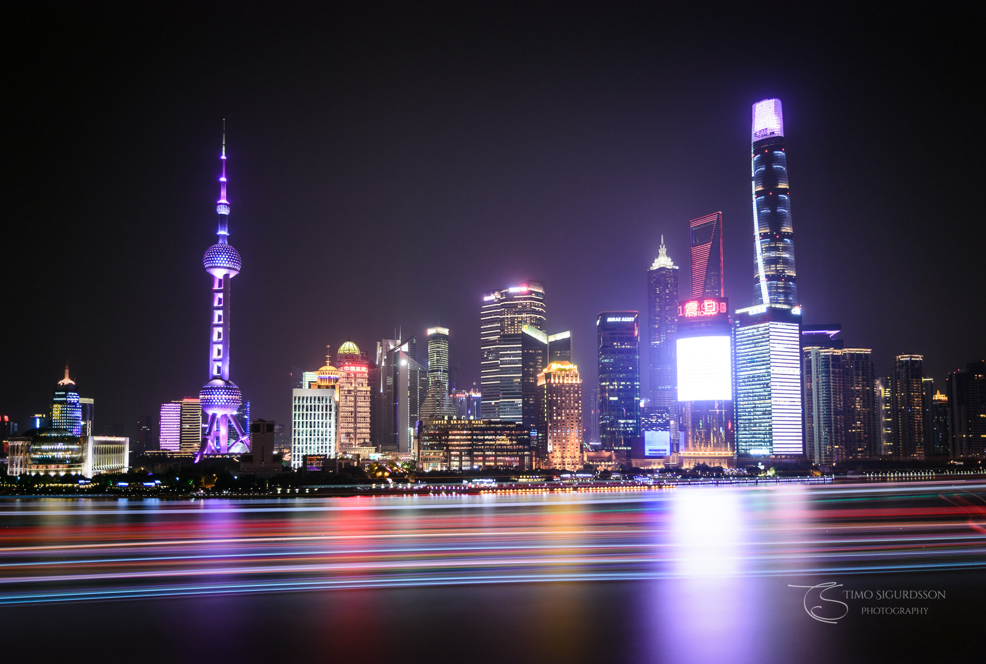 Pudong, Shanghai, China. Skyline at night behind Huangpu river.