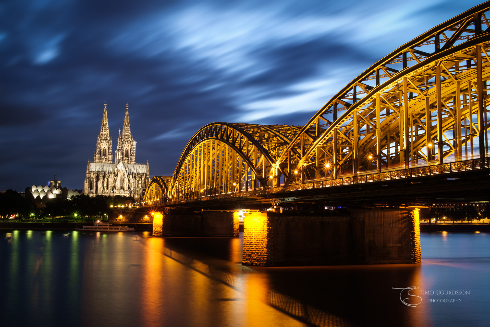 Cologne | Köln, Germany. Cathedral and Hohenzollern bridge at night. River Rhine.