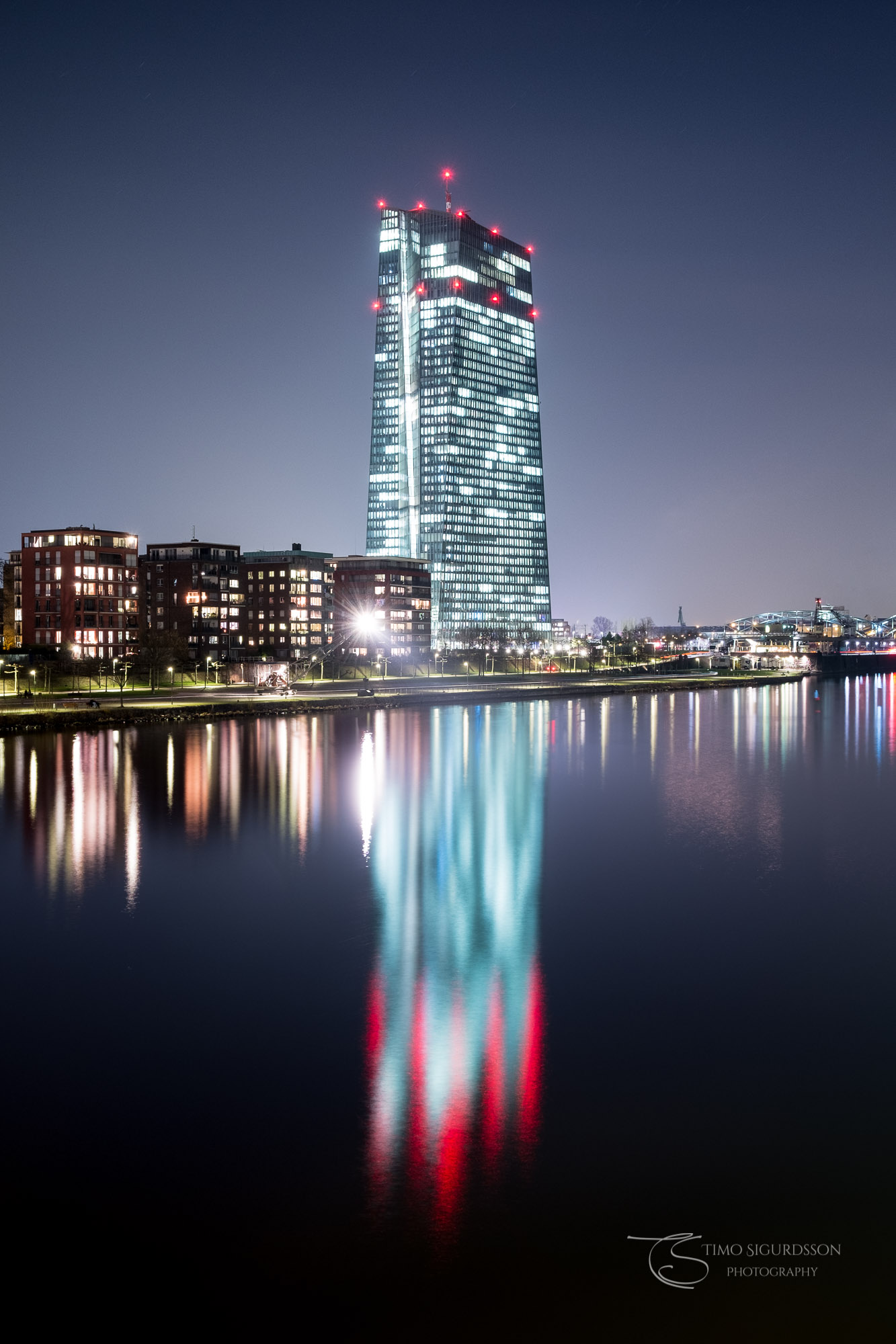 Ostend, Frankfurt, Germany. European Central Bank at night. Reflection in river Main.