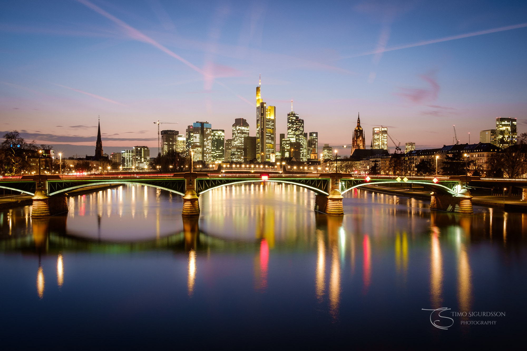 Frankfurt, Germany. Skyline at dusk. Ignatz Bubis bridge and river Main.