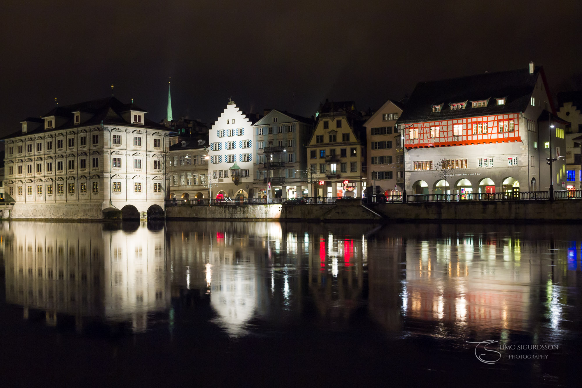 Limmat riverside, Zurich, Switzerland. Reflections at night.